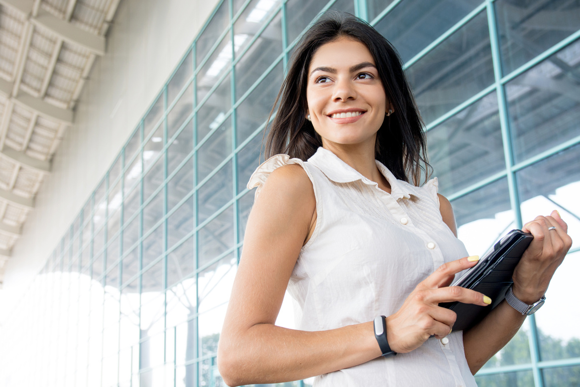 Executive woman standing outside with digital tablet